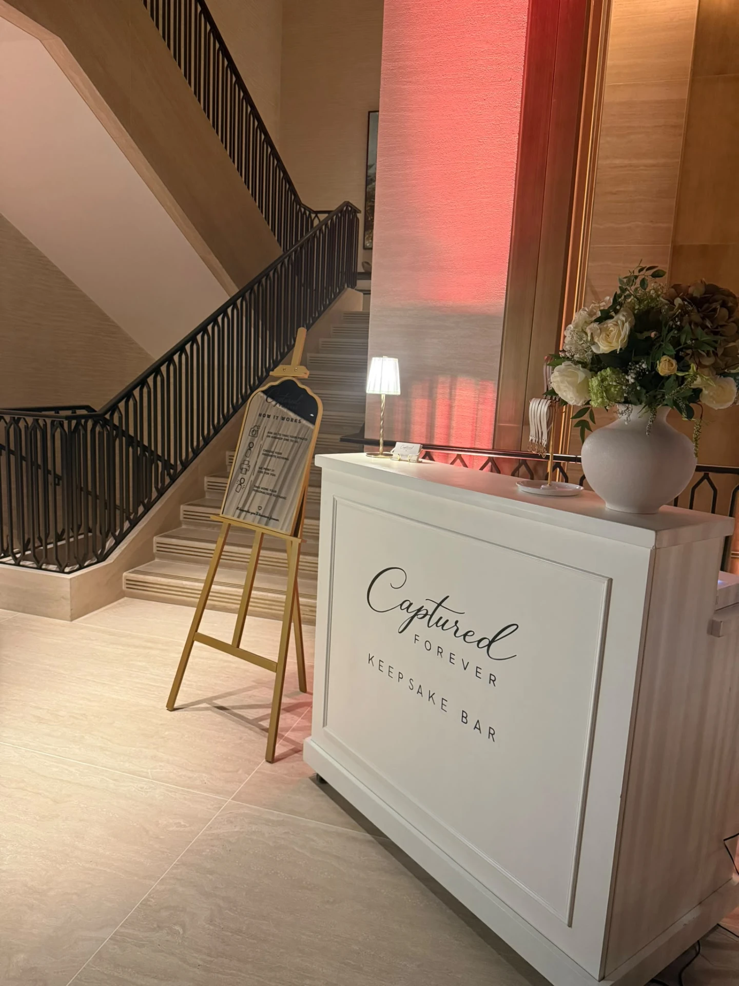 The Keepsake Bar in a hotel lobby beside a staircase